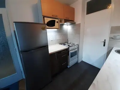 a small kitchen with a refrigerator and a stove at M&Z Apartments in Niš