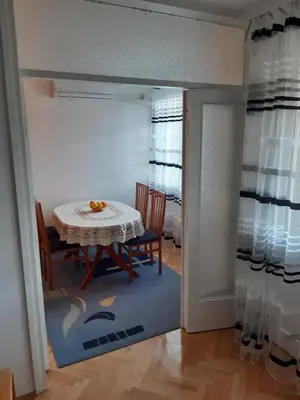 a dining room with a table and chairs in a room at M&Z Apartments in Niš