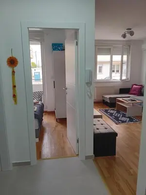 a living room with a door open to a living room at Suncokret in Kruševac