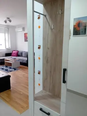 a glass shower door in a living room at Suncokret in Kruševac