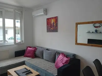 a living room with a couch and a mirror at Suncokret in Kruševac