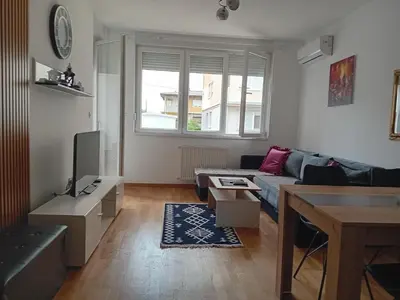 a living room with a couch and a tv at Suncokret in Kruševac