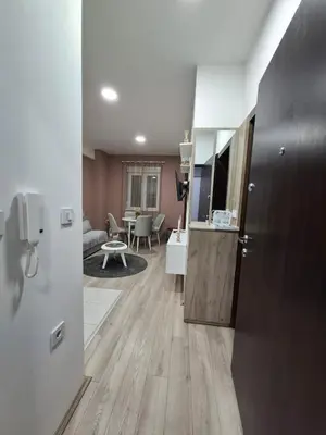 a room with a kitchen and a living room at Apartman Dora in Jagodina