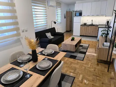 a living room with a table and a couch at Apartman Stefani in Pirot