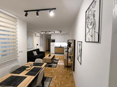 a living room with a table and a couch at Apartman Stefani in Pirot