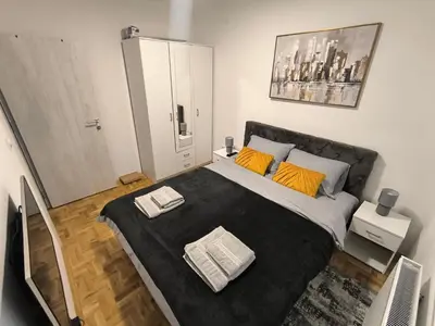 a bedroom with a large bed with two towels on it at Apartman Stefani in Pirot