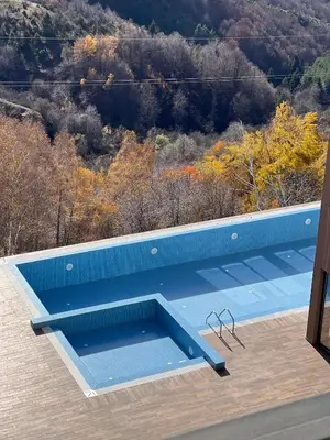 a blue swimming pool on the roof of a house at Snowflake A10 in Kopaonik