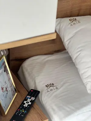 a remote control sitting next to two beds at Snowflake A10 in Kopaonik