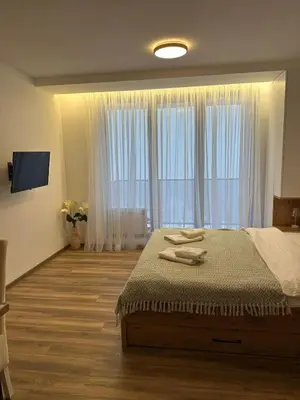 a bedroom with a bed and a large window at Snowflake A10 in Kopaonik
