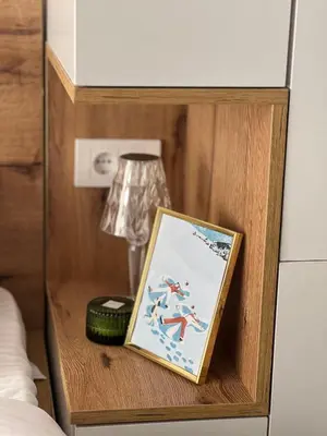 a wooden shelf with a picture on it in a bedroom at Snowflake A10 in Kopaonik