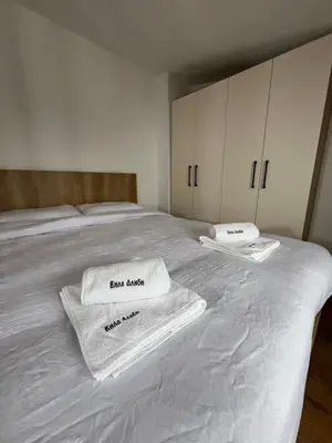 a white bed with two towels on top of it at Apartman Alibi in Kopaonik