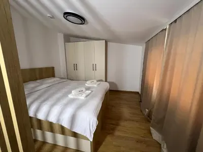 a small bedroom with a bed with towels on it at Apartman Alibi in Kopaonik
