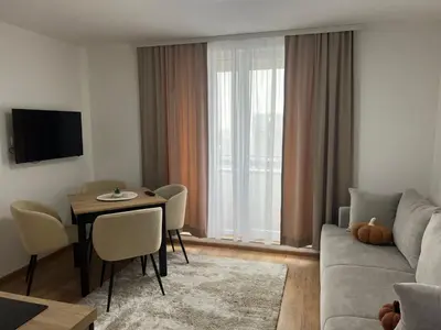 a living room with a couch and a table at Apartman Alibi in Kopaonik