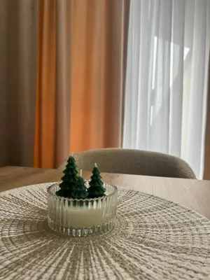 a glass bowl with trees in it on a table at Apartman Alibi in Kopaonik