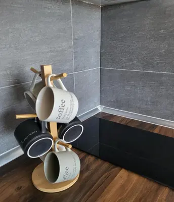 a group of coffee mugs hanging from a wall at Inverno apartman in Kopaonik