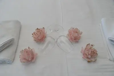 a pair of glasses with pink flowers on a table at Inverno apartman in Kopaonik