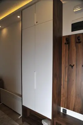 a large white cabinet in a room with a toilet at Inverno apartman in Kopaonik