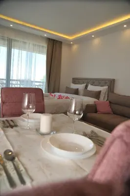 a living room with a table with two wine glasses at Inverno apartman in Kopaonik