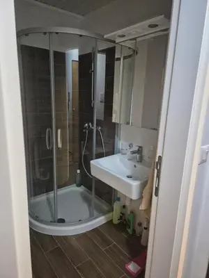 a bathroom with a shower and a sink at Maki Aki Apartman in Jagodina
