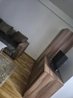 an overhead view of a living room with a couch and a television at Maki Aki Apartman in Jagodina