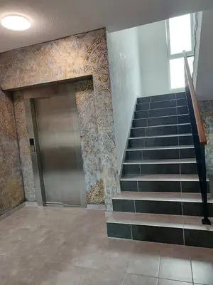 a lobby with a staircase with a door and a staircase at Tiha noć II Vrnjačka Banja in Vrnjačka Banja