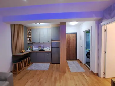 a kitchen with a purple ceiling and wooden floors at Tiha noć II Vrnjačka Banja in Vrnjačka Banja