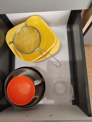 a drawer with a frying pan and other dishes at Tiha noć II Vrnjačka Banja in Vrnjačka Banja