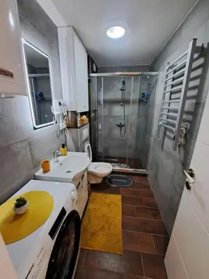 a bathroom with a shower and a sink and a toilet at Tiha noć II Vrnjačka Banja in Vrnjačka Banja