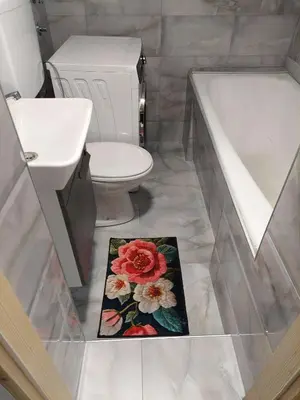 a bathroom with a toilet and a sink and a rug at South Happiness in Leskovac