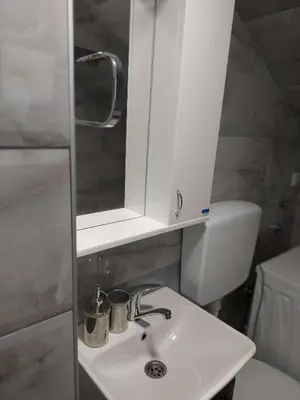 a bathroom with a white sink and a toilet at South Happiness in Leskovac