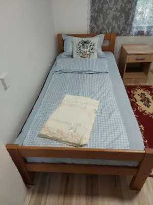 a bed in a bedroom with a blue mattress at South Happiness in Leskovac
