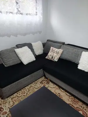 a black couch with pillows on it in a living room at South Happiness in Leskovac
