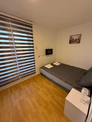 a bedroom with a bed and a large window at Stošić Apartments in Zaječar