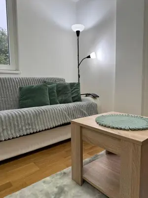 a living room with a couch and a coffee table at Apartman Lambros in Soko Banja