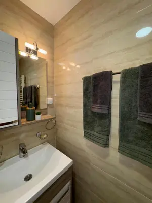 a bathroom with a white sink and a mirror at Apartman Lambros in Soko Banja