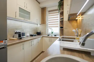 a kitchen with white cabinets and a sink at M&M apartment in Pirot