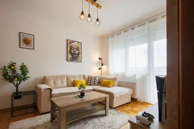 a living room with a couch and a table at M&M apartment in Pirot