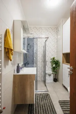 a bathroom with a sink and a shower at M&M apartment in Pirot