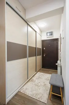 a hallway with a sliding door and a stool at M&M apartment in Pirot