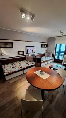 a room with a table and chairs and a couch at Apartman Bjanka 308 in Kopaonik