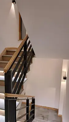 a staircase in a house with white walls at Apartmani U CASA DI LEGNO 2,5,8,11 in Kopaonik