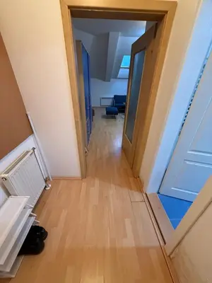 a hallway leading into a room with a door at ROOF Apartman in Jagodina