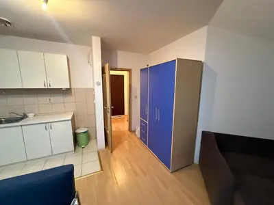 a kitchen with a blue refrigerator in a room at ROOF Apartman in Jagodina
