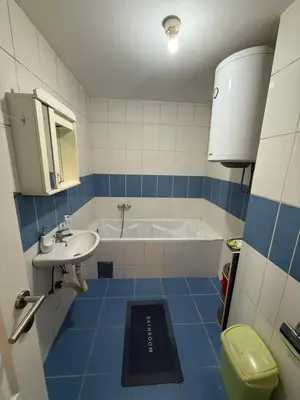 a bathroom with a tub and a sink and a toilet at ROOF Apartman in Jagodina