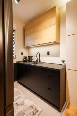 a kitchen with a black counter and a sink at T & T Apartman - 2 bedrooms in Pirot