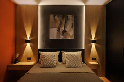 a bedroom with a bed with two lights on it at T & T Apartman - 2 bedrooms in Pirot