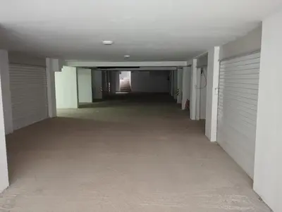 an empty hallway in a building with closed garage doors at T & T Apartman - 2 bedrooms in Pirot