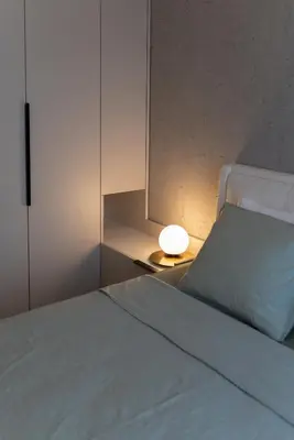 a bedroom with a white bed and a lamp at 501 View Vrnjacka Banja in Vrnjačka Banja