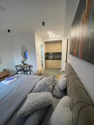 a bedroom with a large bed with pillows on it at M&A apartman in Jagodina