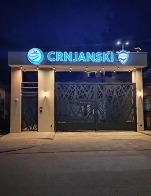 a building with a gate with a sign on it at M&A apartman in Jagodina